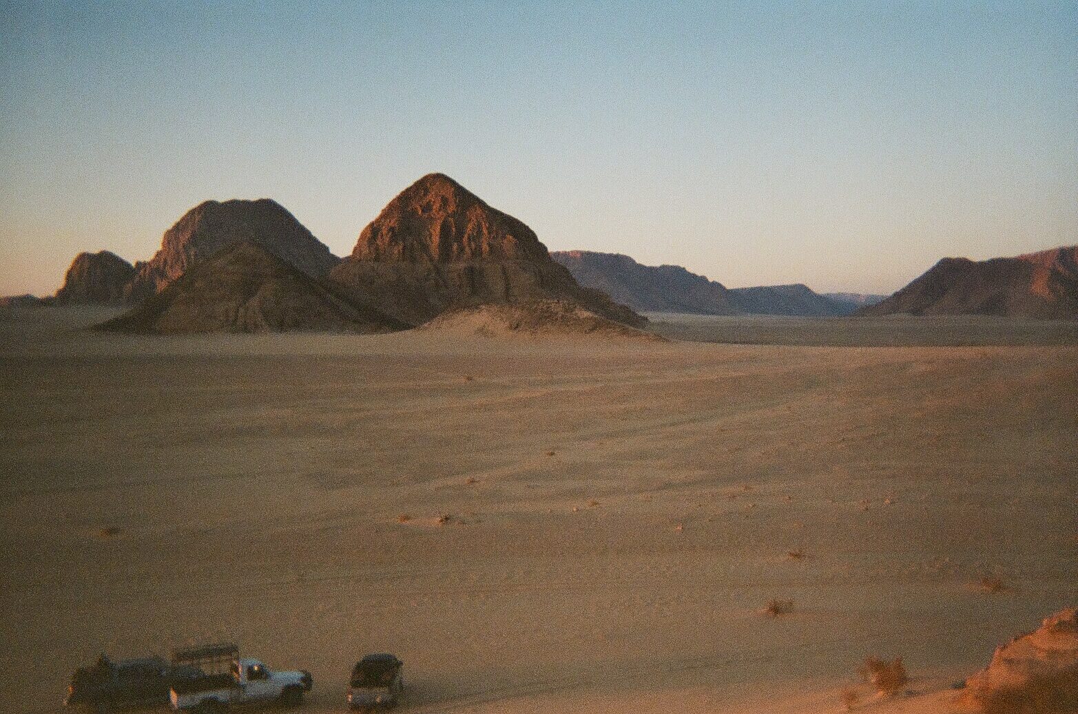 Hikers on a mountain ridge at sunset