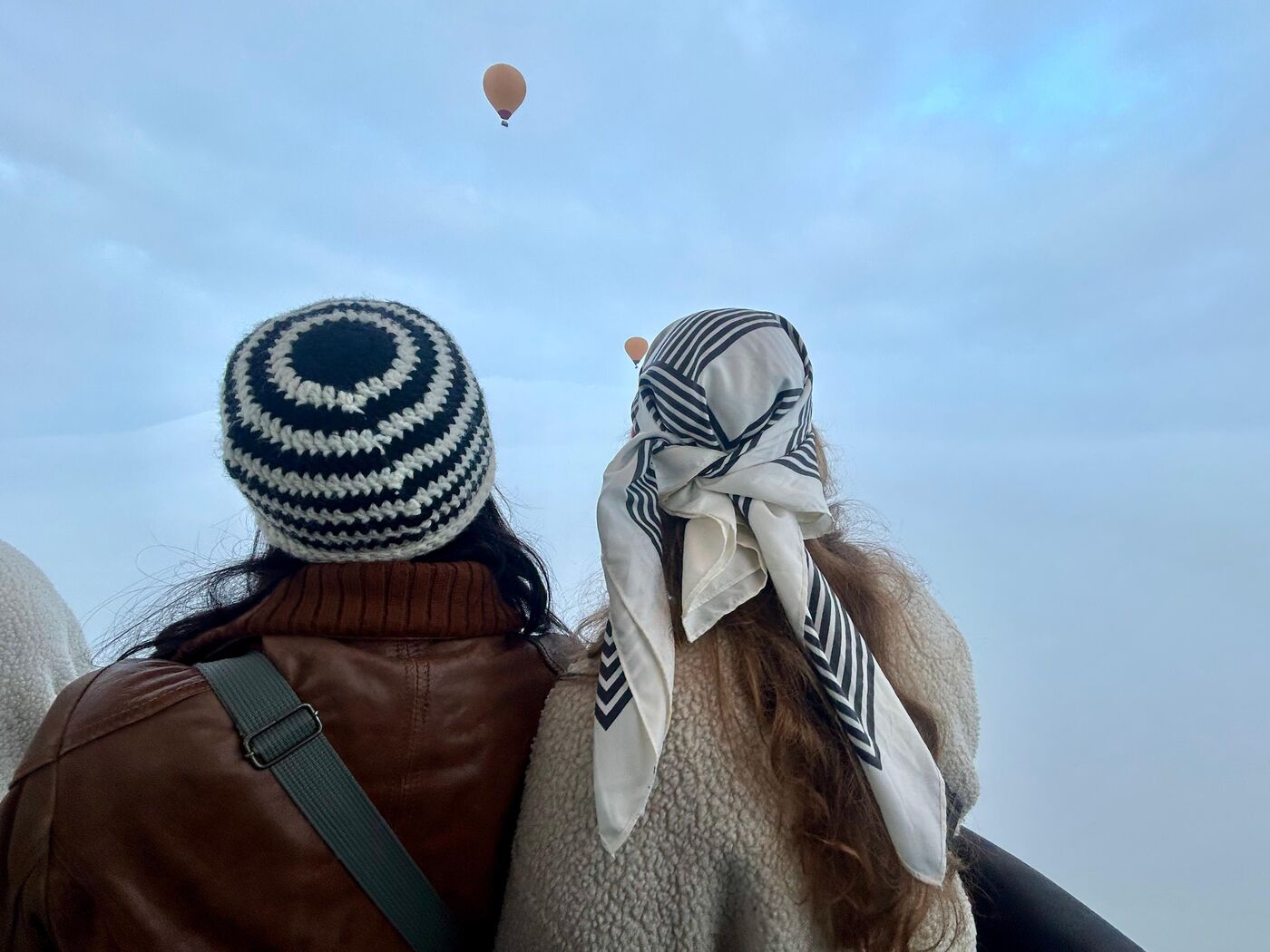 Travelers laughing together at sunset on a WanderMe trip